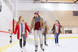 Happy friends on skating rink