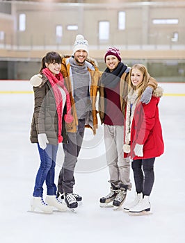 Happy friends on skating rink