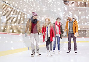 Happy friends on skating rink