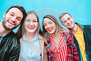 Happy friends taking selfie with turquoise background - Students having fun with technology trends at erasmus university - Youth,