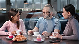 Happy friends talking smiling at cafe coffee break. Shot on RED Raven 4k Cinema Camera