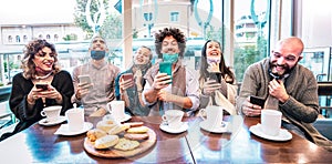 Happy friends using mobile smart phones at coffee bar - New normal lifestyle concept with people wearing open face mask