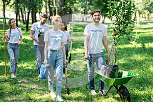 happy friends volunteering and planting trees