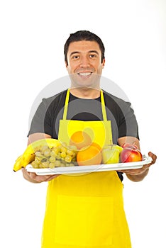 Happy fruiterer offering fresh fruits photo