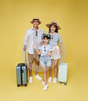 Happy fun asian family vacation portrait. Father, mother and daughters ready for travel flight with suitcase