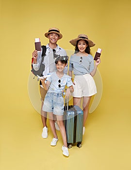 Happy fun asian family vacation portrait. Father, mother and daughters ready for travel flight with suitcase