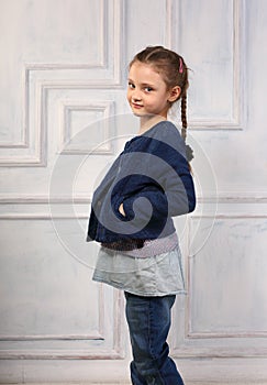 Happy fun smiling kid girl posing in fashion blue jeans, blouse