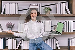 Happy fun university girl teen or business worker doing yoga in the office funny joke relax posture