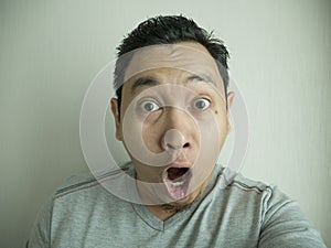 Happy Funny Asian Man Laughing at Camera