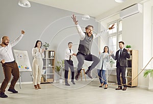 Happy funny business people having fun jump in jumping rope during a meeting in office