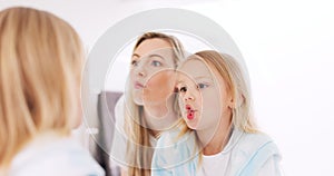 Happy, funny faces and mother with a child looking in the mirror while making a comic joke. Happiness, smile and young