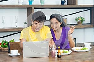 Happy and funny family. Asian lovely couple, beautiful woman and handsome man is having American breakfast