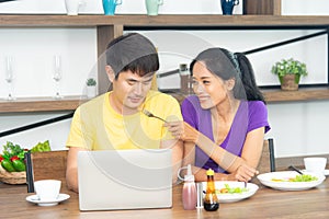 Happy and funny family. Asian lovely couple, beautiful woman and handsome man is having American breakfast