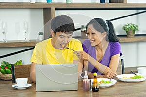 Happy and funny family. Asian lovely couple, beautiful woman and handsome man is having American breakfast