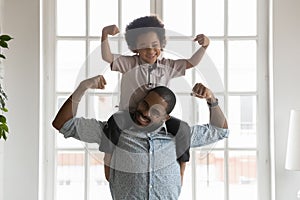 Happy funny kid riding on dads shoulders photo