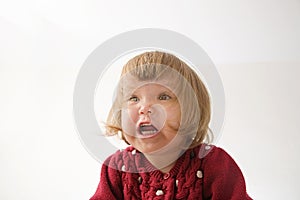 Happy funny little girl emotional playing. cute caucasian blond baby girl with bear and doll