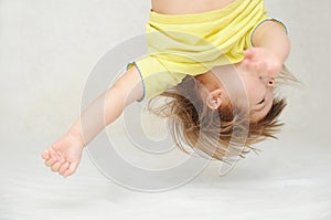 Happy funny little girl upside down head having fun