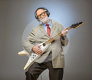 Senior man playing electric guitar