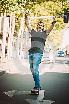 Happy and funny skateboarder ride skateboard through the city st