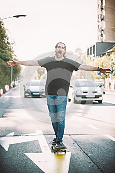 Happy and funny skateboarder ride skateboard through the city st