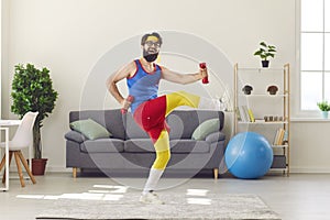 Happy funny young man in retro activewear exercising with dumbbells and laughing