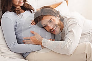 Happy Future Dad Listening Belly Of His Pregnant Wife