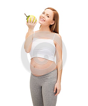 Happy future mother with green apple