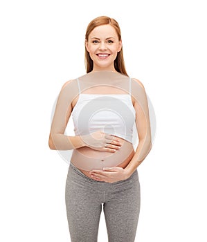 Happy future mother touching her belly