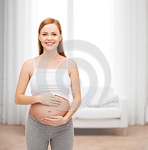 Happy future mother touching her belly