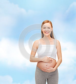 Happy future mother touching her belly