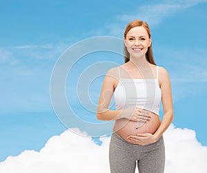 Happy future mother touching her belly