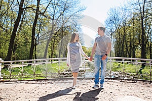 Happy future parents in summer day in park