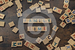 Happy game night. Leisure activities concept. Colourful square wooden letters on a dark wooden table creating the words