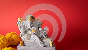 Happy Ganesh Chaturthi festival, Lord Ganesha statue with beautiful texture on red background, Ganesh is hindu god of Success