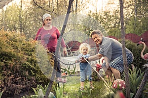 Happy gardener grandparents grandchild together gardening grandparenting concept