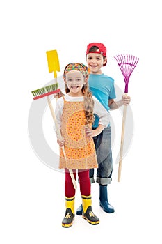 Happy gardener kids - with tools and rubber boots