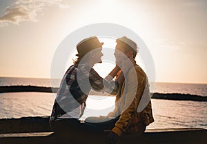 Happy gay couple dating next the beach at sunset - Young lesbian women having a tender romantic moment outdoor