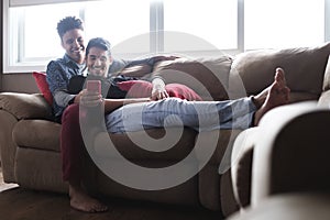 Happy Gay Couple Looking At Pictures On Mobile Phone