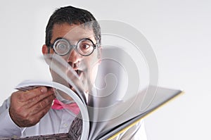 Happy geeky man reads a book photo