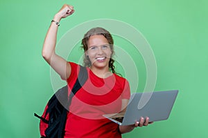 Happy german female student with computer cheering about graduation and good grades