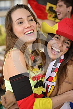 Happy German women sport soccer fans celebrating victory.