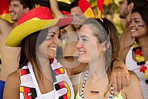 Happy German women sport soccer fans celebrating victory.