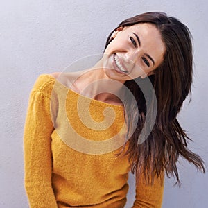 Happy giggles. Portrait of a beautiful young woman laughing and being playful.