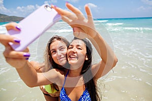 Happy gilrls selfie on beach