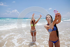 Happy gilrls selfie on beach