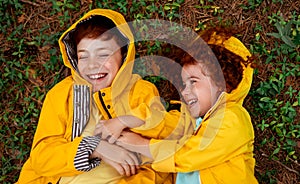 Happy ginger kids playing on forest ground