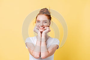 Happy ginger woman in t-shirt reclines on hands