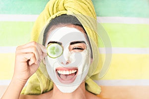 Happy girl applying facial cleanser mask - Young woman having skin care spa day