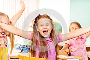 Happy Girl with arms apart laughs during lesson