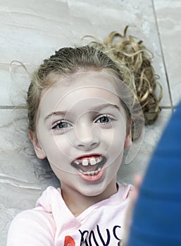 Happy Girl with Autism Playing on the Floor